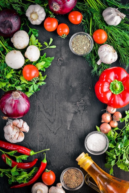 Big set organic food Fresh raw vegetables On a black chalkboard