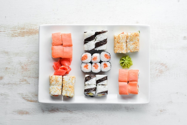 Big Set sushi with soy sauce and wasabi Free space for your text Top view On a white wooden background