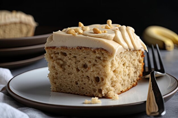 Big slice of banana cake topped with creamy peanut butter frosting