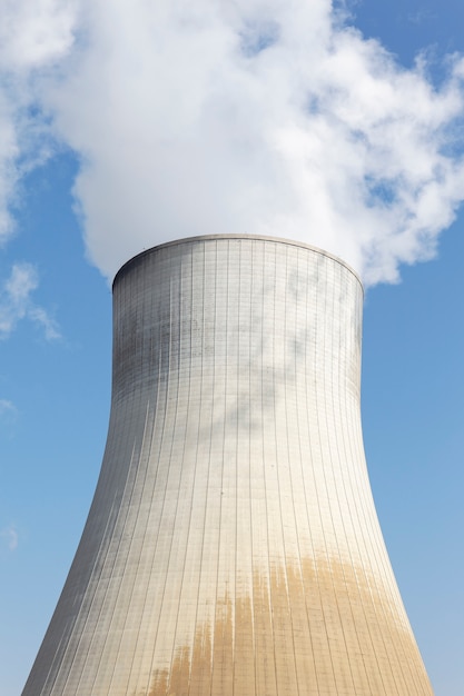 big smokestack of nuclear factory with blue sky