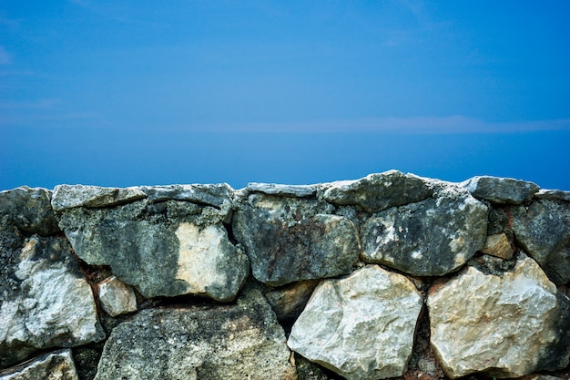 Big stone in front of the blue background 