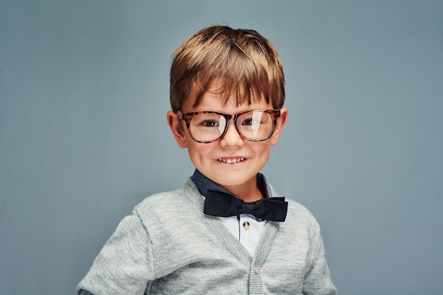 Big style for a little boy Studio portrait of an adorable little boy dressed smartly against a gray background