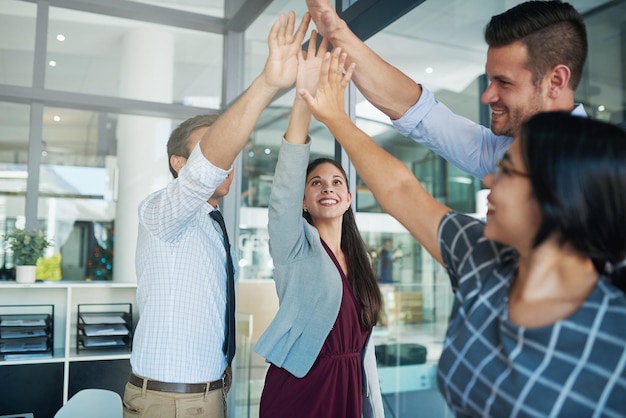 Big success requires big effort Shot of a group of colleagues joining their hands together in solidarity