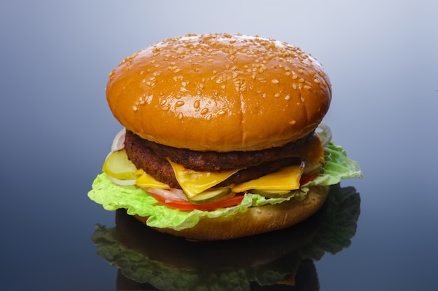 Photo big tasty burger with reflection on glossy surface