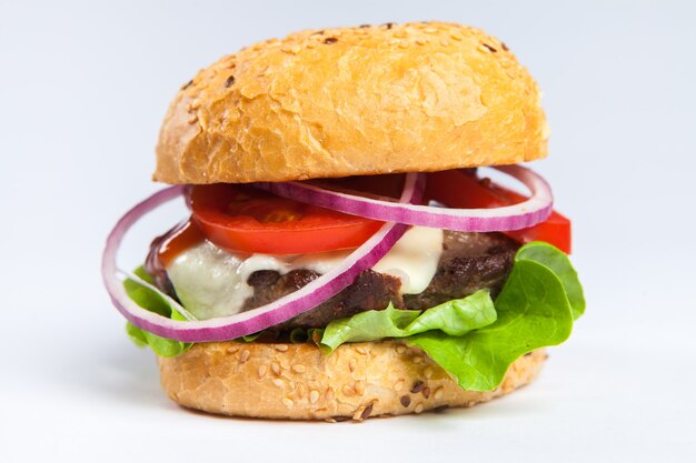 big tasty burger on a wooden table and french fries. Delicious burger with beef tomato cheese and lettuce