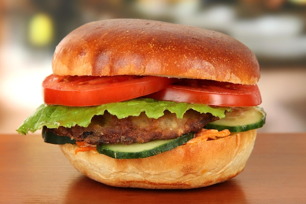 Big and tasty hamburger on table in cafe