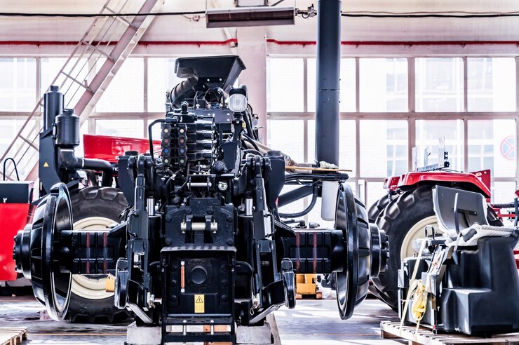 Photo big tractor wheels installation at assembly room at industrial plant