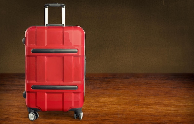 Photo big travel suitcase on wooden background