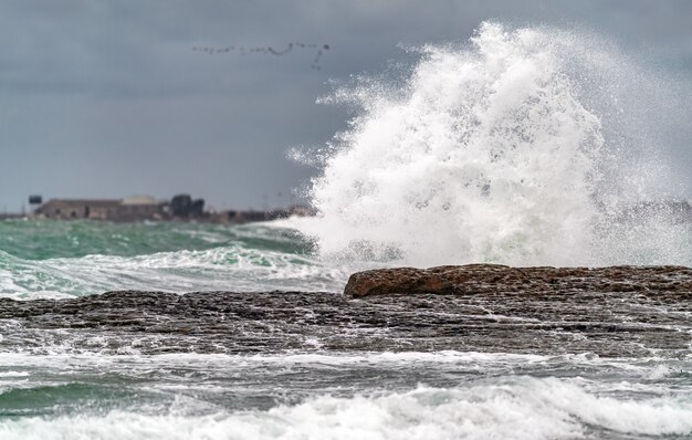 Big waves breaking coastal rocks