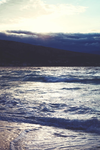 Big waves crushing on stone pier on stormy weather