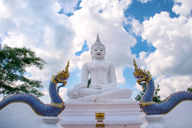 Big white buddha statue and king of Nagas with blue sky Wat Chom tham at mea on in chiang mai, Thailand