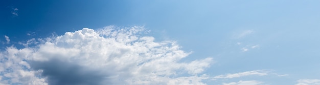 Big white cloud in the blue sky in sunny weather, panorama