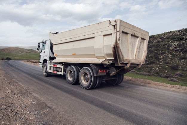 Big white dump truck on the highway