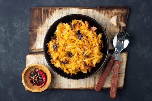 Bigos from fresh cabbage, meat, and prunes