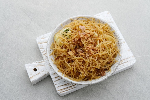 Bihun Goreng or Fried Rice Vermicelli Traditional Indonesian culinary food Served in white plate