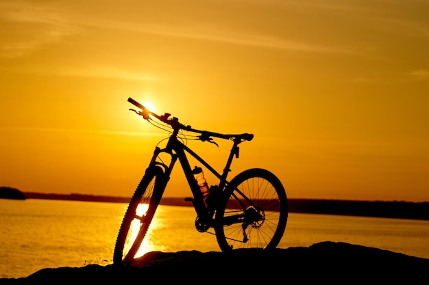 Bike beside water with sunset Active Lifestyle Concept