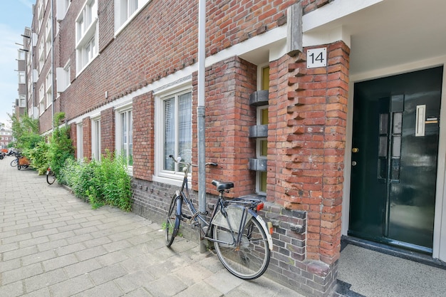 A bike parked outside of a brick building