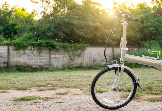 Bike silver folding parked on wall background