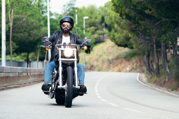 Biker driving his motorcycle on the road