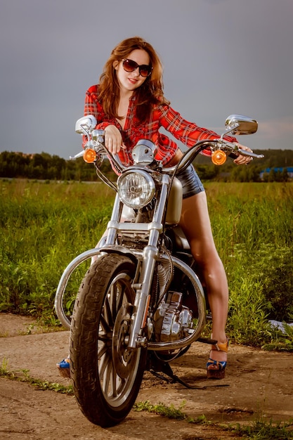 Biker girl with sunglasses and motorcycle