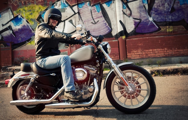 Biker man sits on a bike