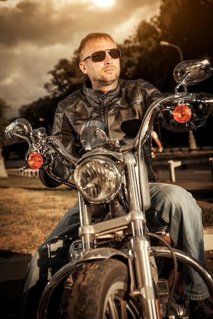 Biker man sits on a bike