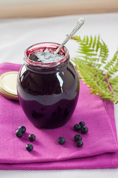 Photo bilberry confiture in a glass jar