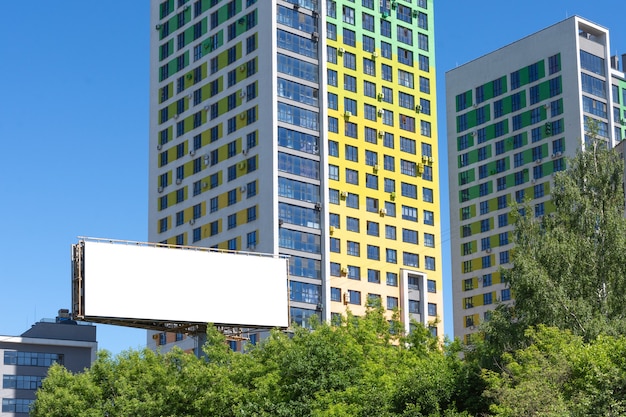 Billboard on the background of a high-rise building.