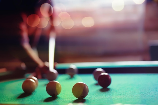 Billiard balls and cue on pool table Russian billiards Closeup of items for the game Background space Concept of sports games Place for an inscription or logo Copy space for site or banner