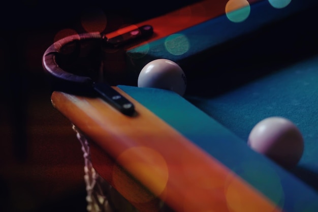 Billiard balls and cue on pool table Russian billiards Closeup of items for the game Background space Concept of sports games Place for an inscription or logo Copy space for site or banner