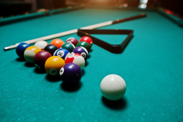 Billiard balls in a pool table at triangle with billiard cue