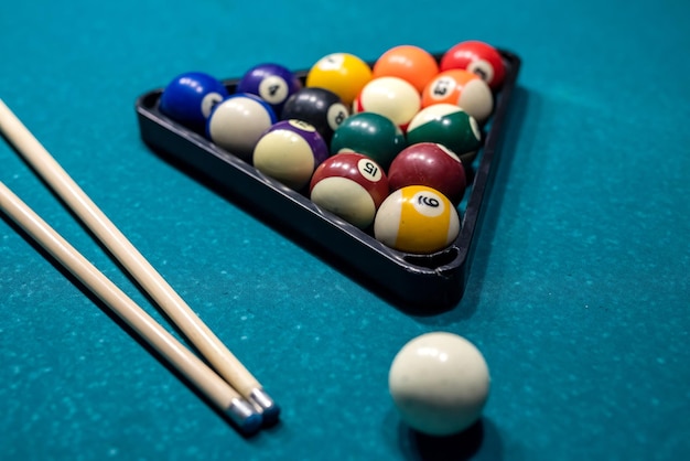 Billiard cue and colour balls on snooker table while game. perfect spend free time