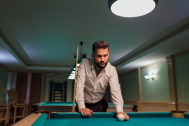 Billiard player at billard table or snooker american billiards pool sport game