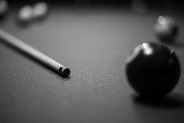 Billiard table in the billiard room with balls and cue