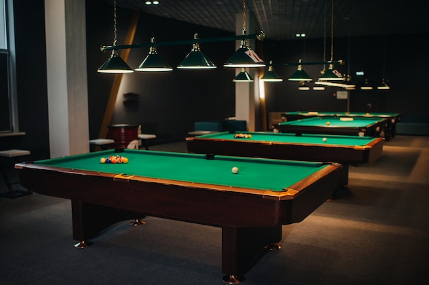 Billiard table with green surface and balls in the billiard club.Pool Game.