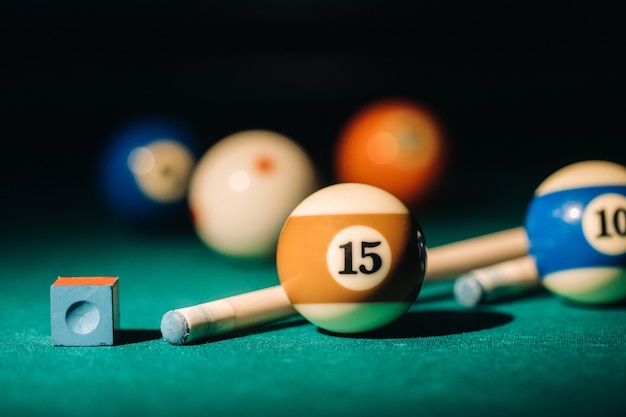 Billiard table with green surface and balls in the billiard club. Pool Game.