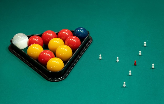 Billiards balls and pins on table