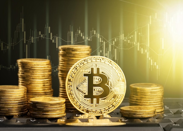 Binanceコインの仮想通貨と金貨の積み重ねがコンピュータの取引チャートの背景です