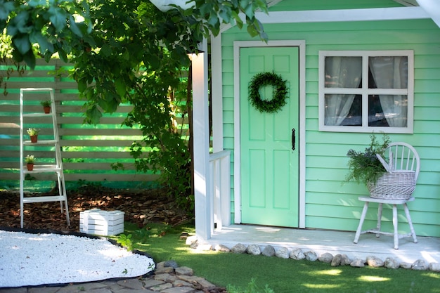 Binnengevel groene houten veranda woning met tuinmeubelen