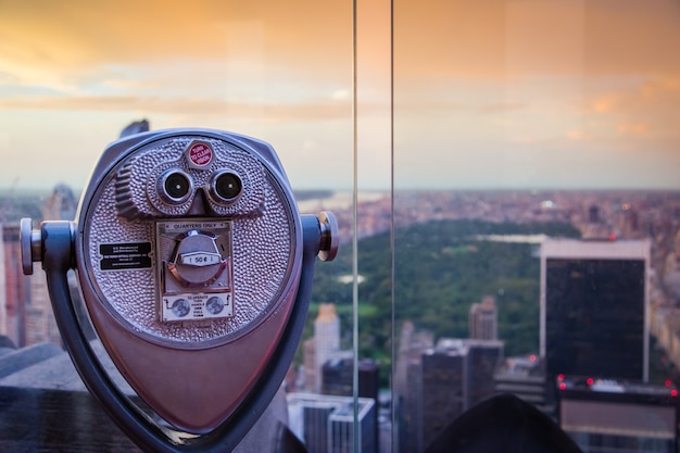 Binoculars on an overlook at sunset, overlooking central park