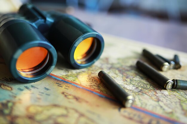 Photo binoculars and reflection in lenses map and shells background