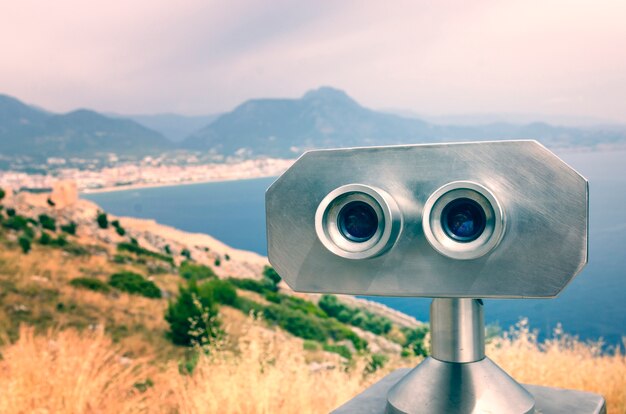 Binoculars with the view on Alanya town in Turkey