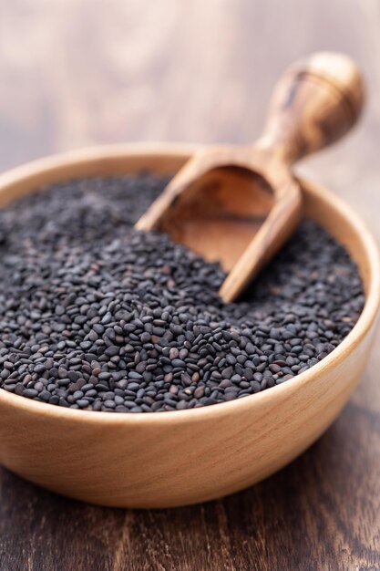 Bio natural black sesame seeds on wooden bowl