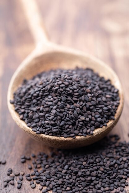 Bio natural black sesame seeds on wooden spoon