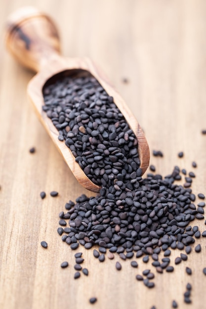 Bio natural black sesame seeds on wooden spoon