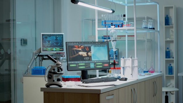 Photo biochemistry desk with scientific computer in laboratory