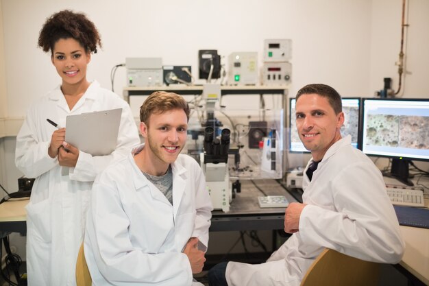 Biochemistry students using large microscope and computer