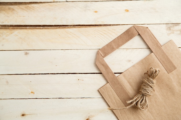 Biodegradable environmentally friendly cardboard bag on wooden background