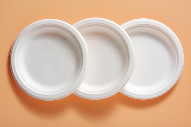 Biodegradable paper plates on a beige background top view