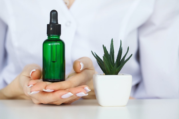 Biological test. Woman holding flask in lab. The scientist,dermatologist testing the organic natural product in the laboratory